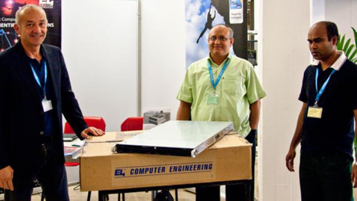 ICTP Associates Mamunur Rashid Talukdar (centre) and M. Shahjahan (right) receiving HPC equipment donated to the University of Rajshahi from Vincenzo Nuti of E4 (left)