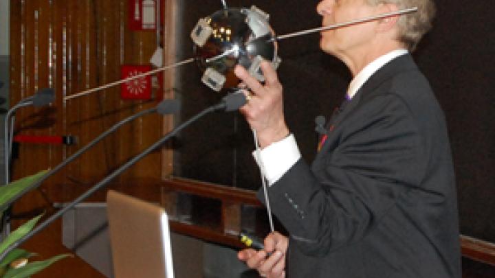 Larry Kazmerski demonstrating one of the first applications of photovoltaics: to power a satellite