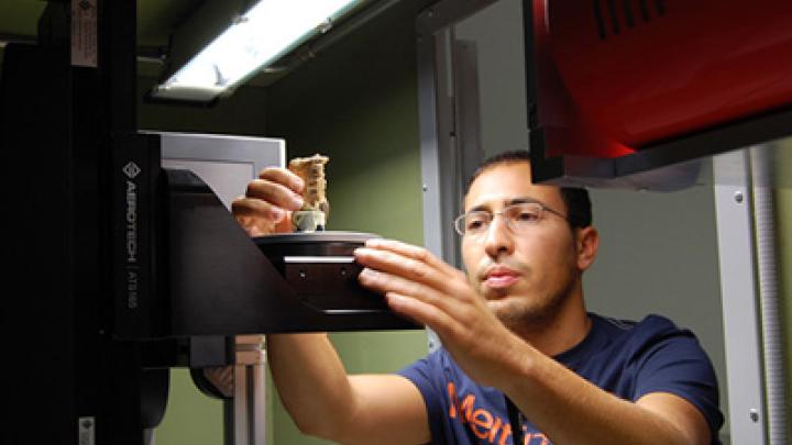 Federico Bernardini examines a 7,000-year-old human tooth using tomography equipment